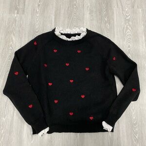 black sweater with heart accents
